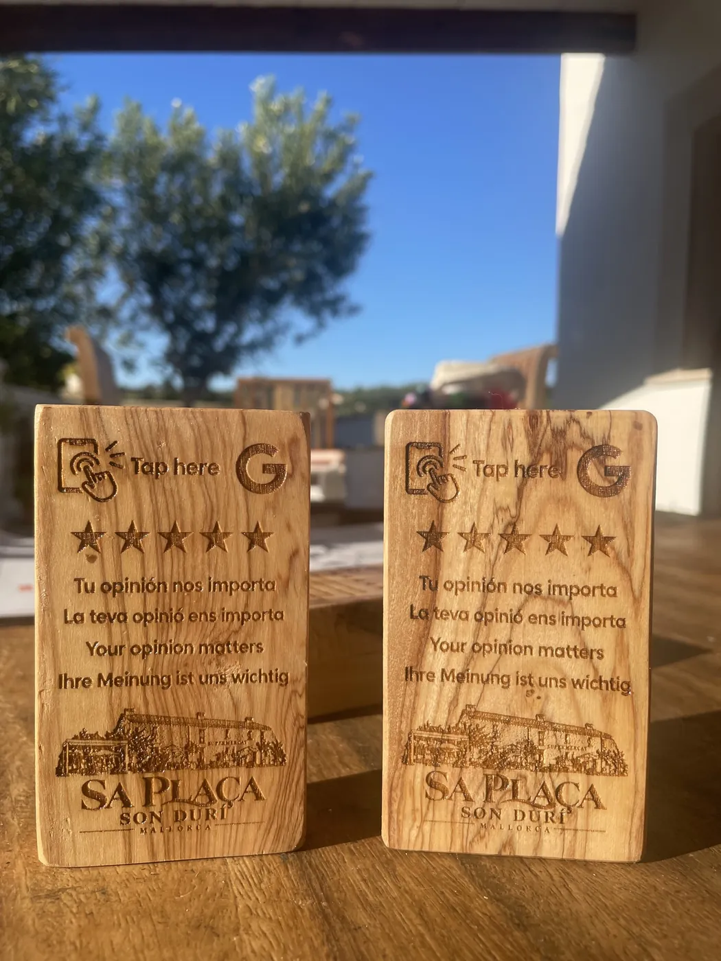 Dos placas de ullastre grabadas con estrellas y texto en cuatro idiomas